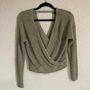 Green sweater, fun back, and fitting waist.